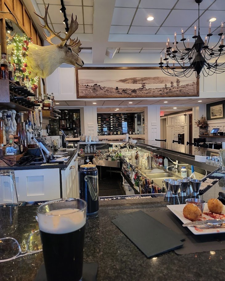 Upscale dining space with fireplace and set tables.