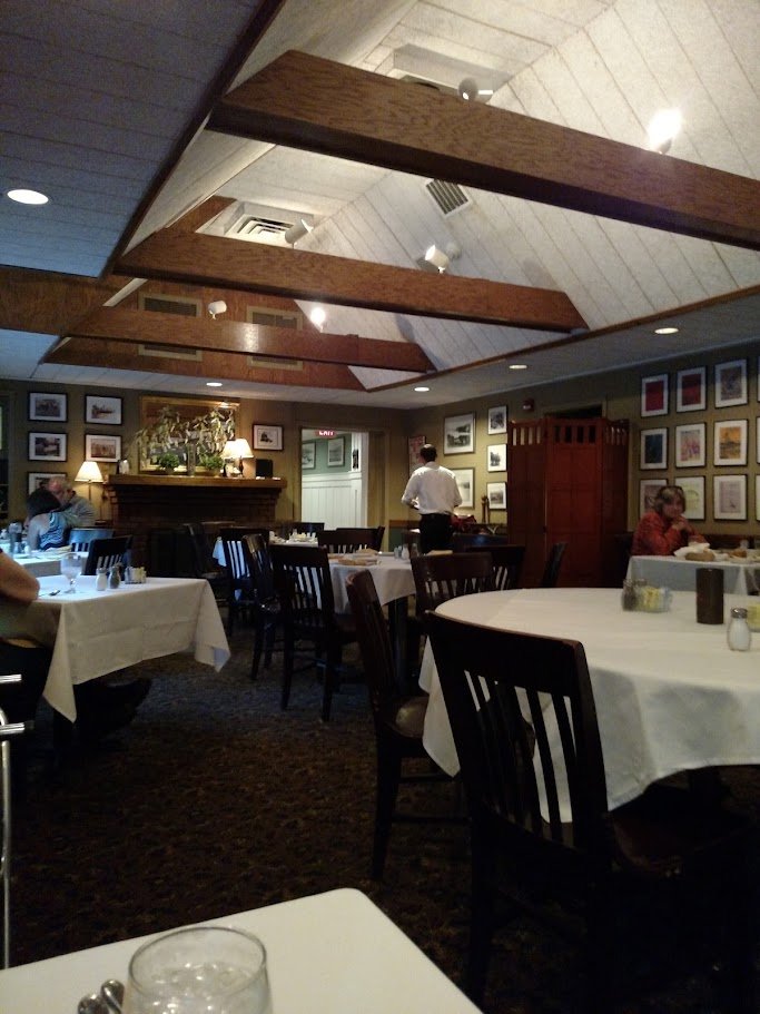 Restaurant interior with bar seating and cozy atmosphere.