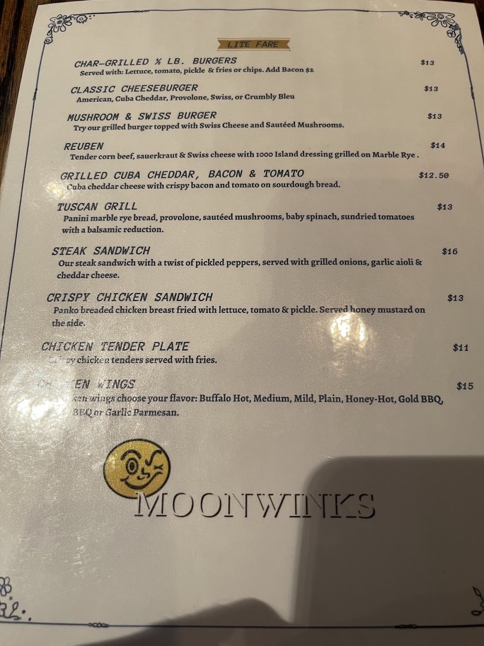 Printed menu with appetizers and main courses.